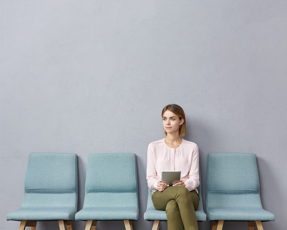 Young woman sitting in waiting room 