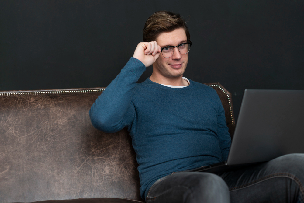 Modern man checking social media on laptop 