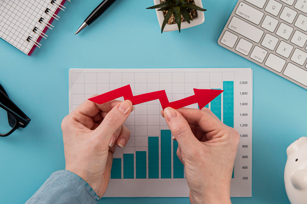 business items with growth chart and hands holding arrow